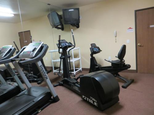 a gym with several exercise bikes and a television at Hawthorn Suites Las Vegas in Las Vegas