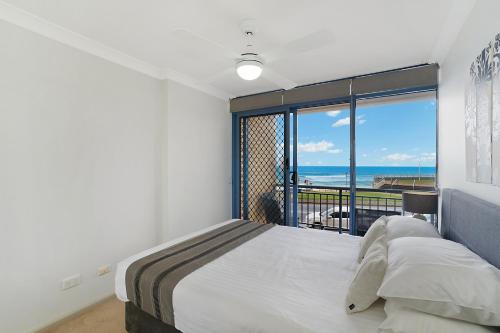a bedroom with a bed and a view of the ocean at Newcastle Short Stay Accommodation - Sandbar Newcastle Beach in Newcastle