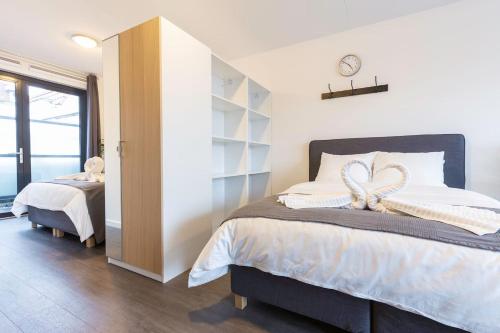a bedroom with a bed with a heart decoration on it at New Loft Apt View Delft city center balcony Utopia2c in Delft