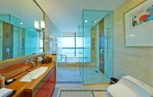 a bathroom with a shower and a sink and a toilet at Empark Grand Hotel Hangzhou Bay Ningbo in Ningbo
