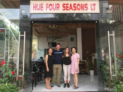 a group of people standing in front of a restaurant at Hue Four Seasons Hotel in Hue