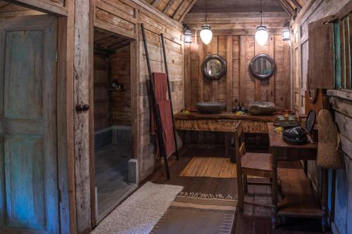 a room with a table and a sink in a cabin at Ratua Private Island Resort in Aimbuei Bay