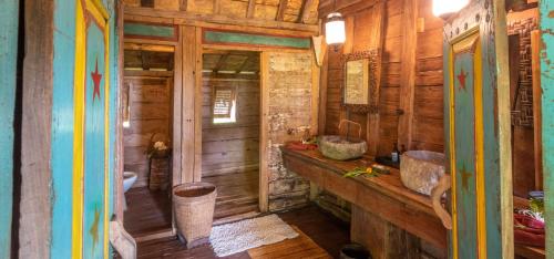a bathroom with two sinks in a wooden cabin at Ratua Private Island Resort in Aimbuei Bay