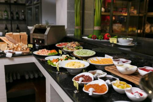 a buffet line with many different types of food at Azure Sapa Hotel in Sa Pa