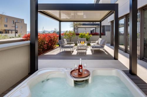an outdoor jacuzzi tub on the roof of a house at Shell Luxury Residences with Pool and Whirlpool in Zadar
