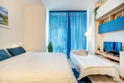 a bedroom with two beds and a large window at HaPPy INN Studio Historic center, Self check-in, AC, Parking in the undergrnd Garage, in Vilnius