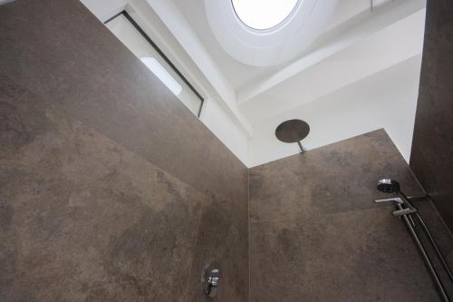 a bathroom with a shower with a stone wall at eifel5star - Burgfriedstraße in Daun