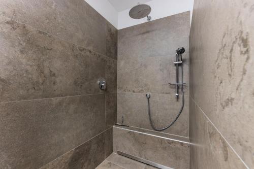 a bathroom with a shower with a shower head at eifel5star - Burgfriedstraße in Daun