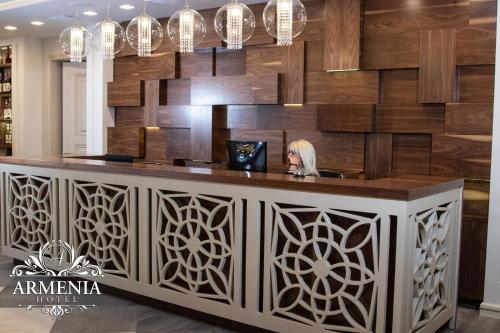 a bar in a restaurant with a wall of wood at Armenia in Nerkʼin Giratʼagh