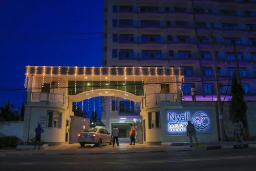 a building with christmas lights on it at night at Nyali Golf View Residence in Mombasa