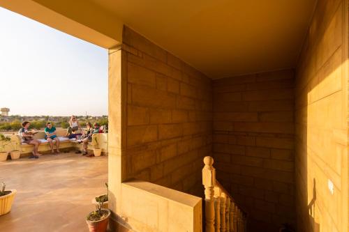 a group of people sitting on the patio of a house at Boutique Helsinki in Jaisalmer
