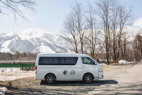 a white van parked on the side of a road at Hotel Villa Hakuba by HHG in Hakuba