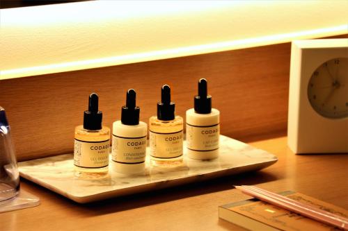 four bottles of moisturizers on a tray on a table at Auberge AZABU in Kyoto