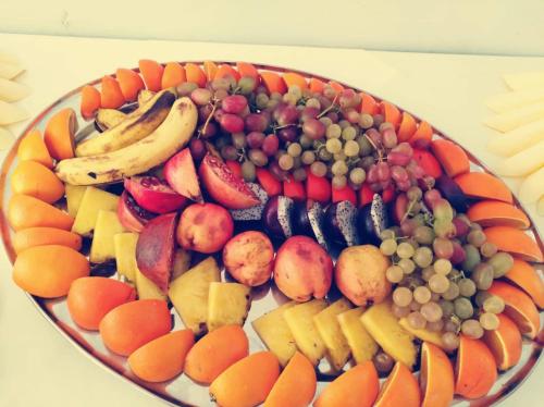 a plate of fruit and vegetables on a table at Hotel Tókert Szálloda és Étterem in Lillafüred
