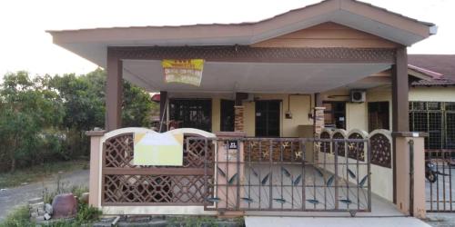 a house with a gate in front of it at Zara Homestay in Machang