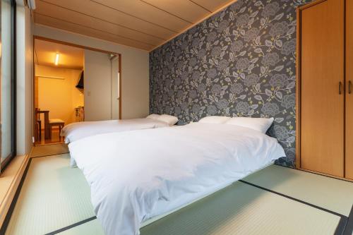 Giường trong phòng chung tại Ecol Beppu