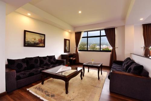 a living room with a couch and a table at Park Village Resort by KGH Group in Kathmandu