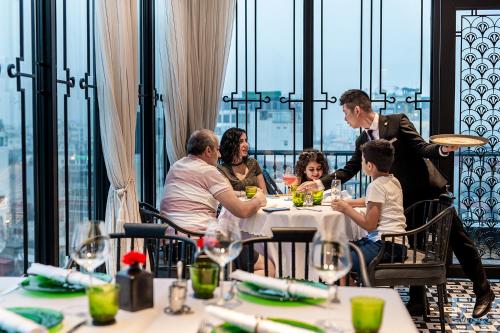 a group of people sitting at a table in a restaurant at La Siesta Premium Hang Be in Hanoi