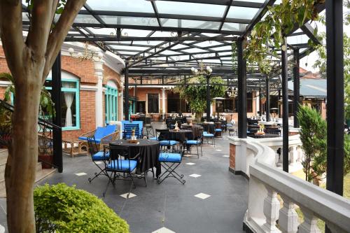 a patio with tables and chairs in a building at Park Village Resort by KGH Group in Kathmandu