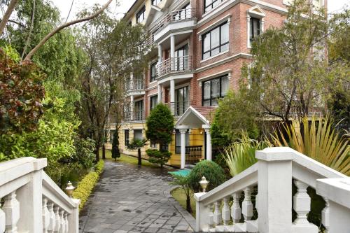 a brick building with a white fence in front of it at Park Village Resort by KGH Group in Kathmandu