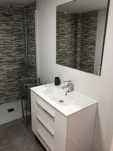 a bathroom with a white sink and a mirror at MISTRAL 17 in El Campello