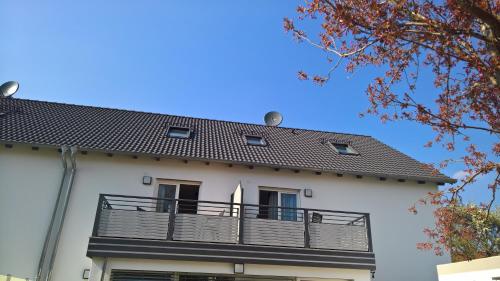 a white building with a balcony on it at Aparthotel Sebastian in Erding