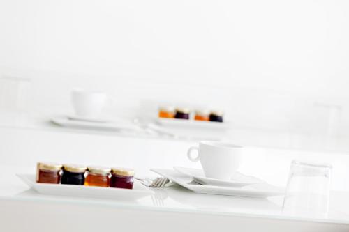 a white table with two plates and a cup of tea at Blc Design Hotel in Paris