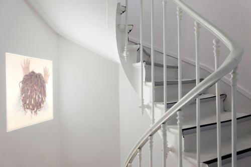 a staircase with a picture on the wall next to a stair case at Blc Design Hotel in Paris