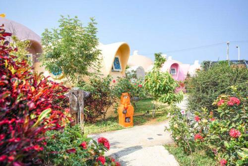 a house with a garden with flowers in front of it at Kenting Ha-Bi Star Fort in Hengchun