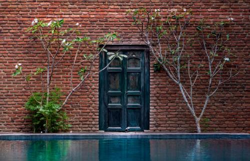 a red brick building with a door and a window at Ayur Ayur Resort & Ayurveda Retreat in Negombo
