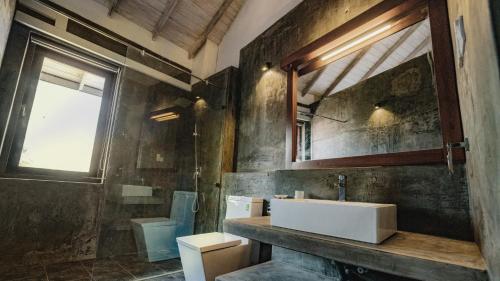 a bathroom with a sink and a toilet at Ayur Ayur Resort & Ayurveda Retreat in Negombo