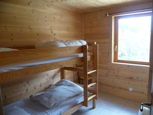 a log cabin with two bunk beds in it at La Cour in Notre-Dame-de-Bellecombe