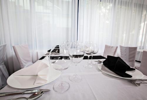 a white table with wine glasses on top of it at Hotel Jadran in Split