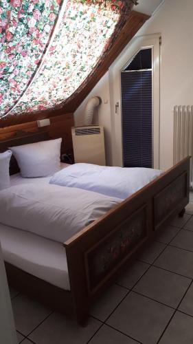 a bedroom with a large bed with a large window at Hotel Restaurant Anna in Ramstein-Miesenbach
