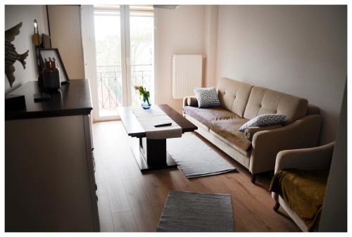 a living room with a couch and a table at Color 24 Premium in Stalowa Wola