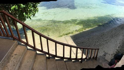 a stairway leading down to the water from the ocean at Babylon Oslob Coast Guesthouse in Oslob