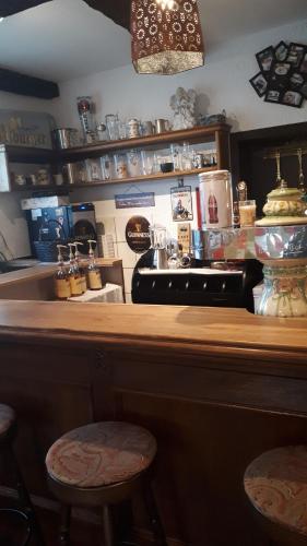a bar with two stools sitting at a counter at Hotel Restaurant Anna in Ramstein-Miesenbach