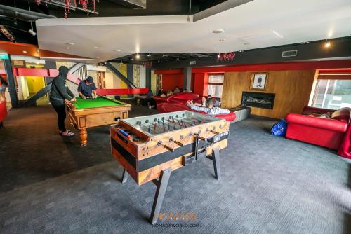 a group of people playing a game of foosball at Nomads Queenstown Hostel in Queenstown