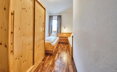 a small bedroom with a bed and a window at Ski & Bike Appartements Forsthaus in Saalbach Hinterglemm