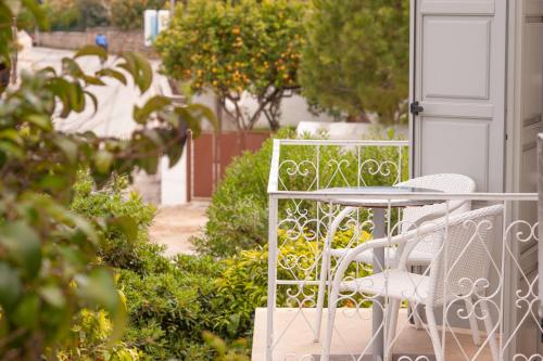 a table and chairs sitting on a porch at Mimoza in Spetses