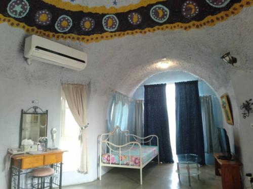 a room with a bedroom with a crib and a window at Kenting Ha-Bi Star Fort in Hengchun