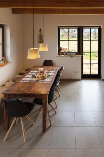 a dining room with a wooden table and chairs at Chata Hrozenka WELLNESS in Nový Hrozenkov