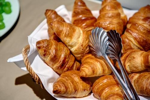 a basket filled with croissants on top of a table at Sarroglia Hotel in Bucharest