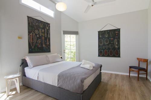 a bedroom with a large bed and a window at Atticus Cottage in Bright
