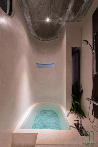 a jacuzzi tub in the corner of a bathroom at The Memory - Danang in Da Nang