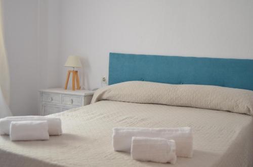 a bedroom with a bed with two towels on it at Apartament Piramide Complex Alicante Beach in Alicante