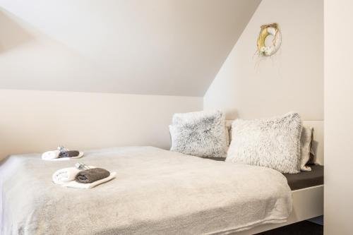 a bedroom with a bed with white sheets and pillows at Penzion Bílá voda in Harrachov