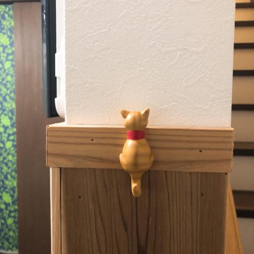 a figurine of a cat on a wooden door at Stay Nikko Guesthouse in Nikko