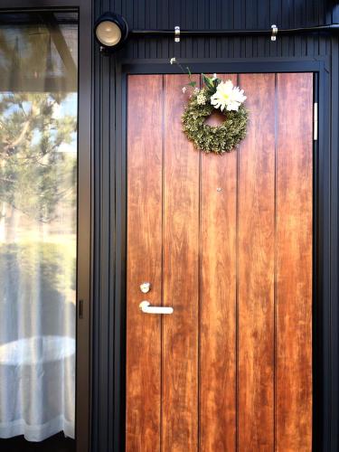 a wooden door with a wreath on it at Stay Nikko Guesthouse in Nikko
