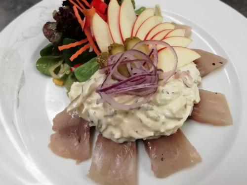 a plate of food with vegetables and dip on it at Hotel-Restaurant Walserhof in Wasserburg am Bodensee
